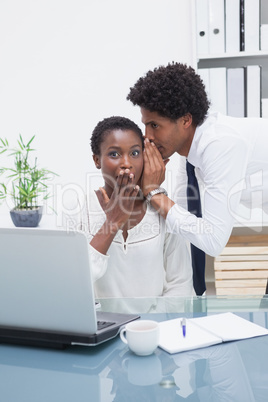 Man telling a business secret at his colleague