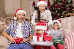 Pretty family posing with gifts during christmas