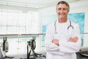 Confident doctor standing in fitness studio