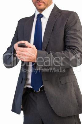Focused businessman texting on his mobile phone