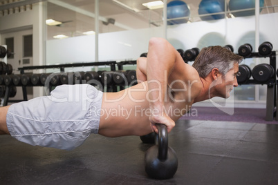 Fit man using kettlebells in his workout