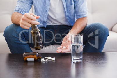 Close up of man showing pills and holding bottle