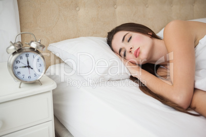 Pretty brunette sleeping in bed