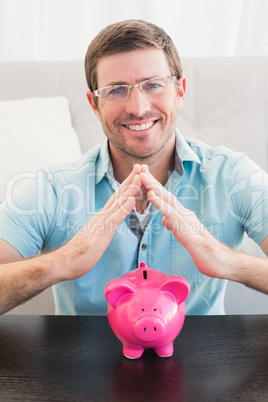 Smiling man with piggy bank