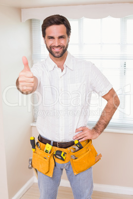 Handyman smiling at camera in tool belt