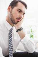 Worried businessman sitting on couch