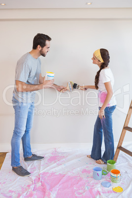 Cute couple painting the wall