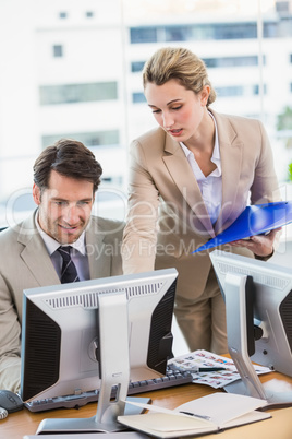 Woman showing her colleague something on the screen