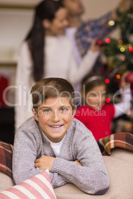 Smiling son leaning on the couch