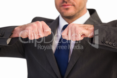 Mid section of a businessman with clenched fist