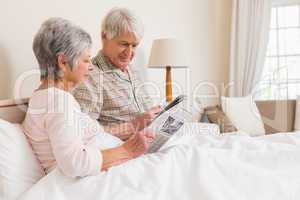Senior couple relaxing in bed