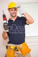 Construction worker posing while holding power tool