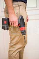 Construction worker holding power tool