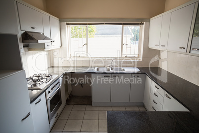 Empty kitchen with white cabinets