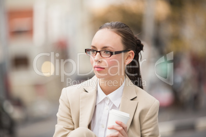Young businesswoman holding take away coffee