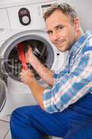 Handyman fixing a washing machine