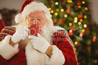 Santa claus drinking a hot beverage