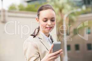 Young businesswoman sending a text