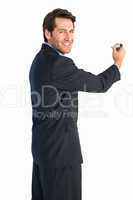 Businessman writing with marker while looking at camera