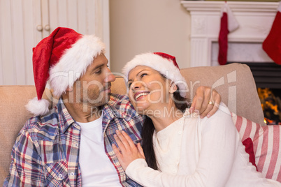 Smiling couple cuddling on the couch