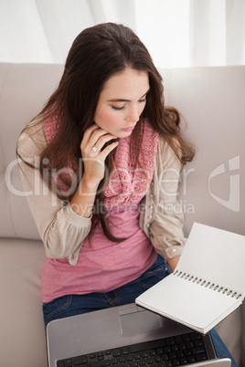 Pretty brunette studying with laptop