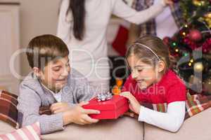 Brother and sister holding a gift