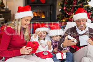 Festive shocked family exchanging gifts