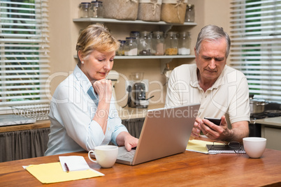 Senior couple working out their bills