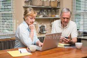 Senior couple working out their bills