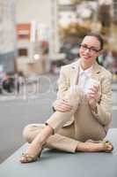 Young businesswoman holding take away coffee