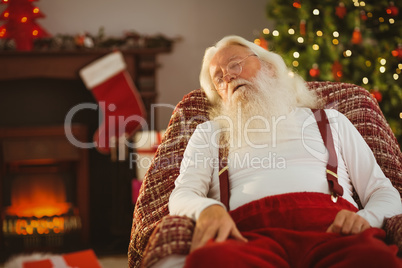 Santa claus napping on the armchair