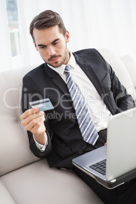 Businessman shopping online on his couch