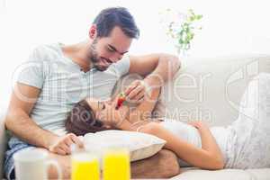 Cute couple relaxing on couch at breakfast