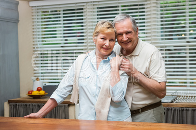 Senior couple smiling at the camera together