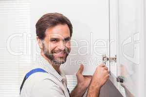 Handyman fixing the cupboard