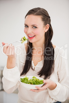 Pretty brunette preparing a healthy salad