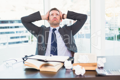 Stressed businessman taking his head