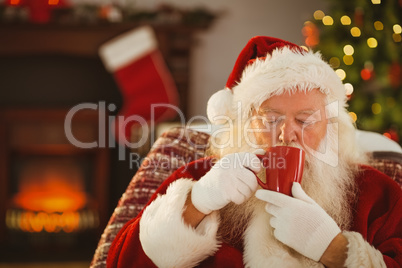 Father christmas drinking a hot beverage
