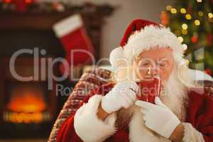 Father christmas drinking a hot beverage