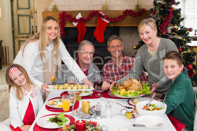 Two women serving christmas dinner to their family