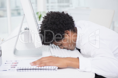 Handsome photo editor sleeping at desk