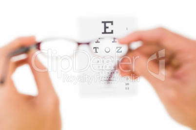 Glasses held up to read eye test