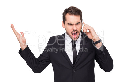 Angry businessman gesturing on the phone