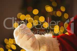 Hand of father christmas holding engagement ring