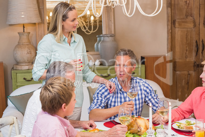 Pretty family speaking together at christmas dinner