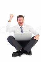 Businessman using laptop and cheering