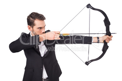 Elegant businessman shooting bow and arrow