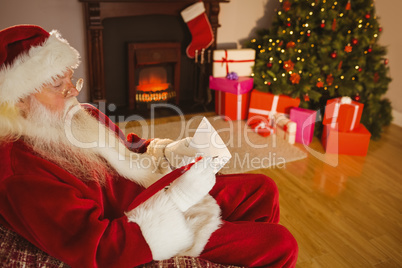 Concentrated santa writing list on scroll