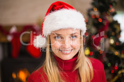 Festive blonde smiling in santa hat