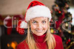 Festive blonde smiling in santa hat